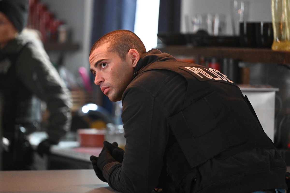 Torres leaning on a table in 'Chicago P.D.' Season 10