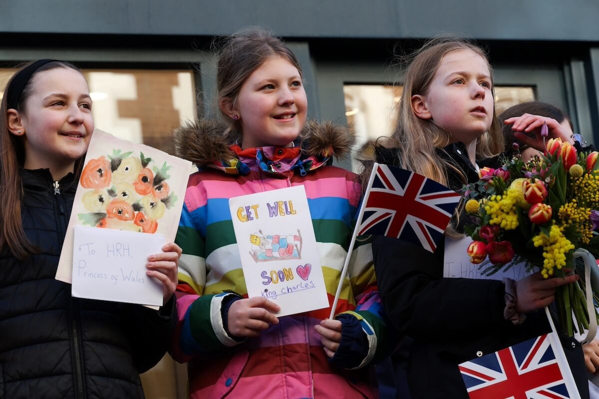 Girls holding get-well-cards for Kate Middleton and King Charles