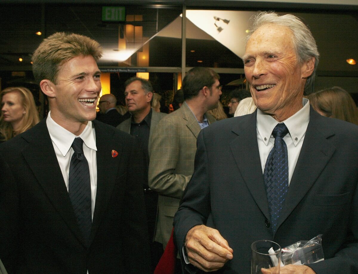 Scott Eastwood smiling at Clint Eastwood at the premiere of the movie 'Flags of Our Fathers'.