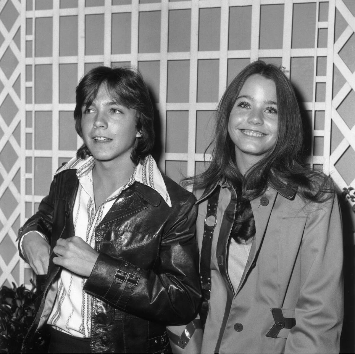 Actor and musician David Cassidy leans against wall with Susan Dey