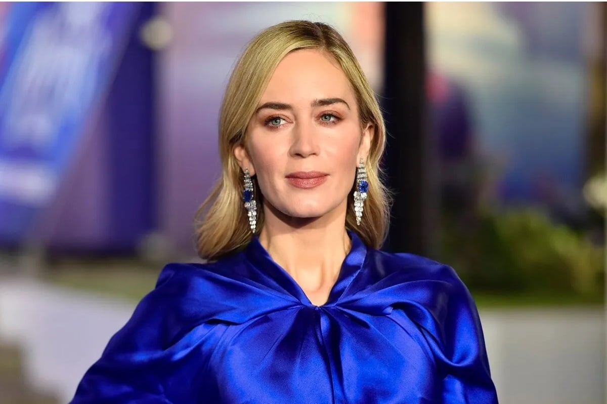 Emily Blunt posing while wearing a blue outfit.