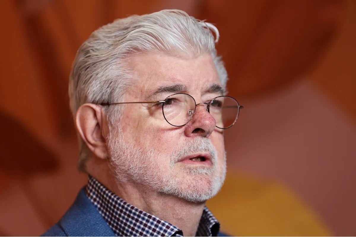 George Lucas posing at the Museum of Modern Art.