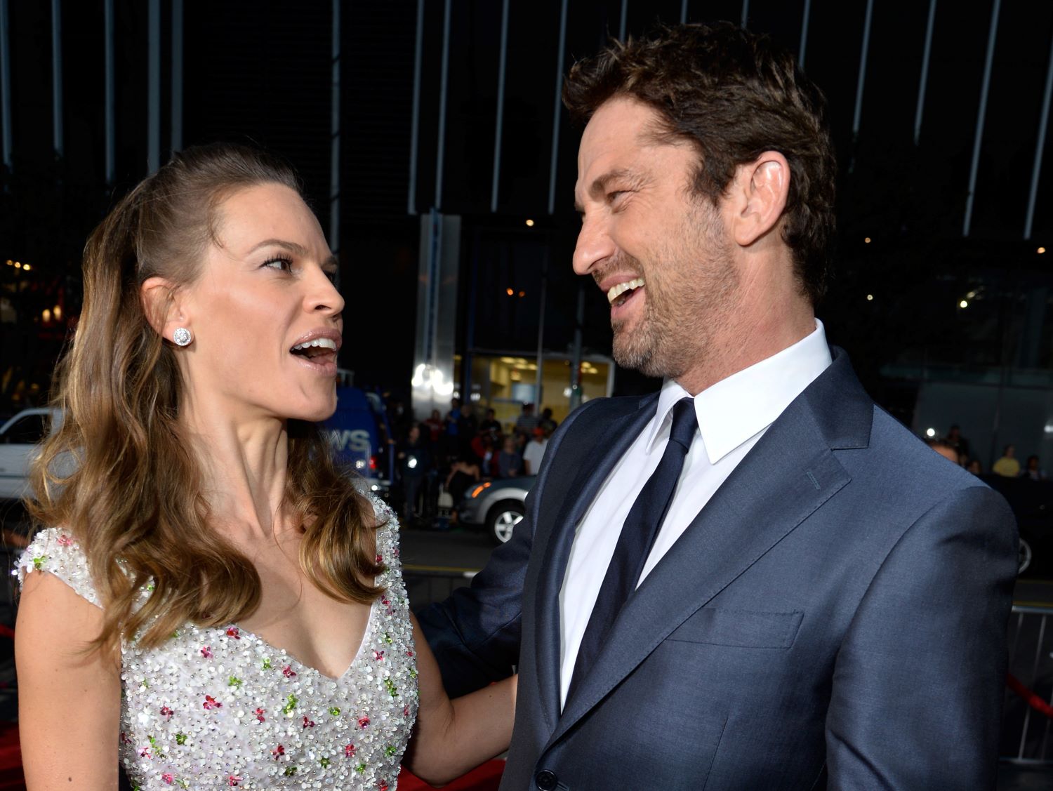 Gerard Butler and Hilary Swank laughing together.