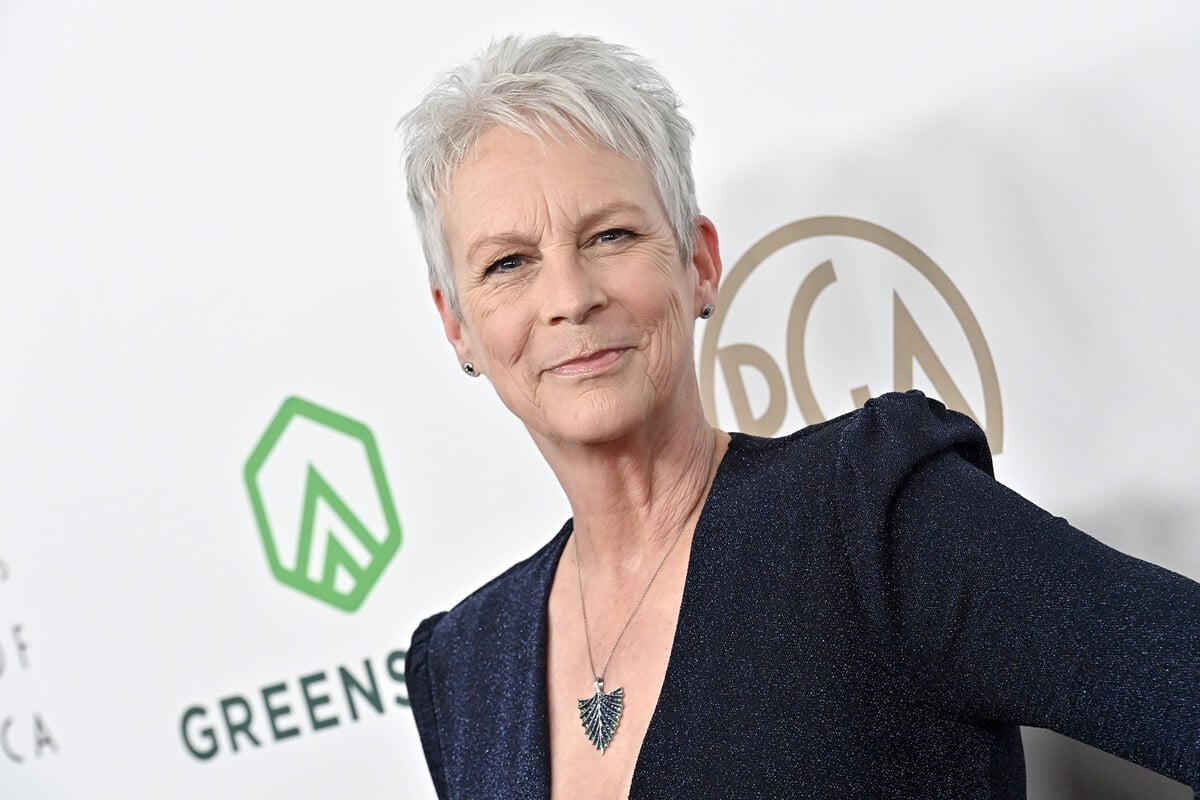 Jamie Lee Curtis posing at the the 2023 Producers Guild Awards in a black dress.