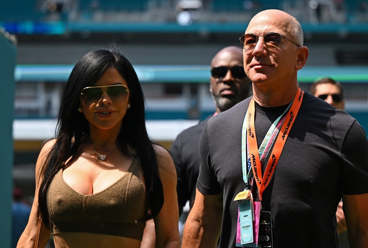 Jeff Bezos and Lauren Sanchez walk in the Paddock prior to final practice ahead of the F1 Grand Prix of Miami at Miami International Autodrome.