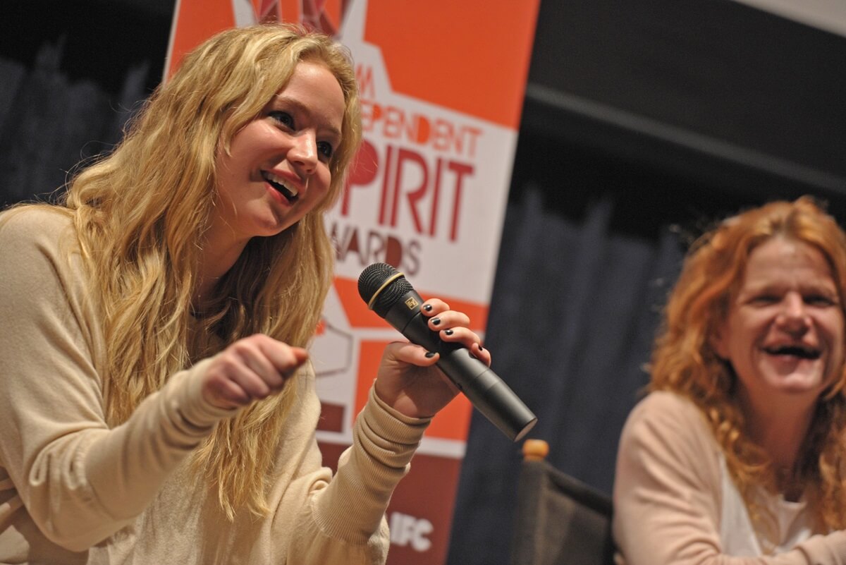 Jennifer Lawrence speaking at the 2011 Film Independent Spirit Awards Screening of "Winter's Bone" in a tan shirt.