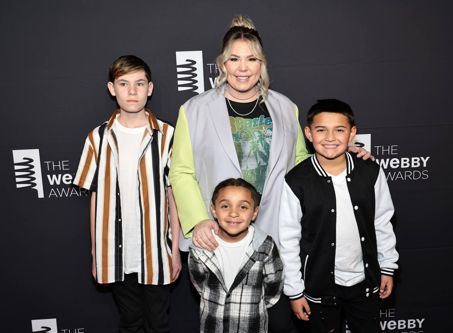 'Teen Mom 2' star Kailyn Lowry with 3 of her kids smiling at an event