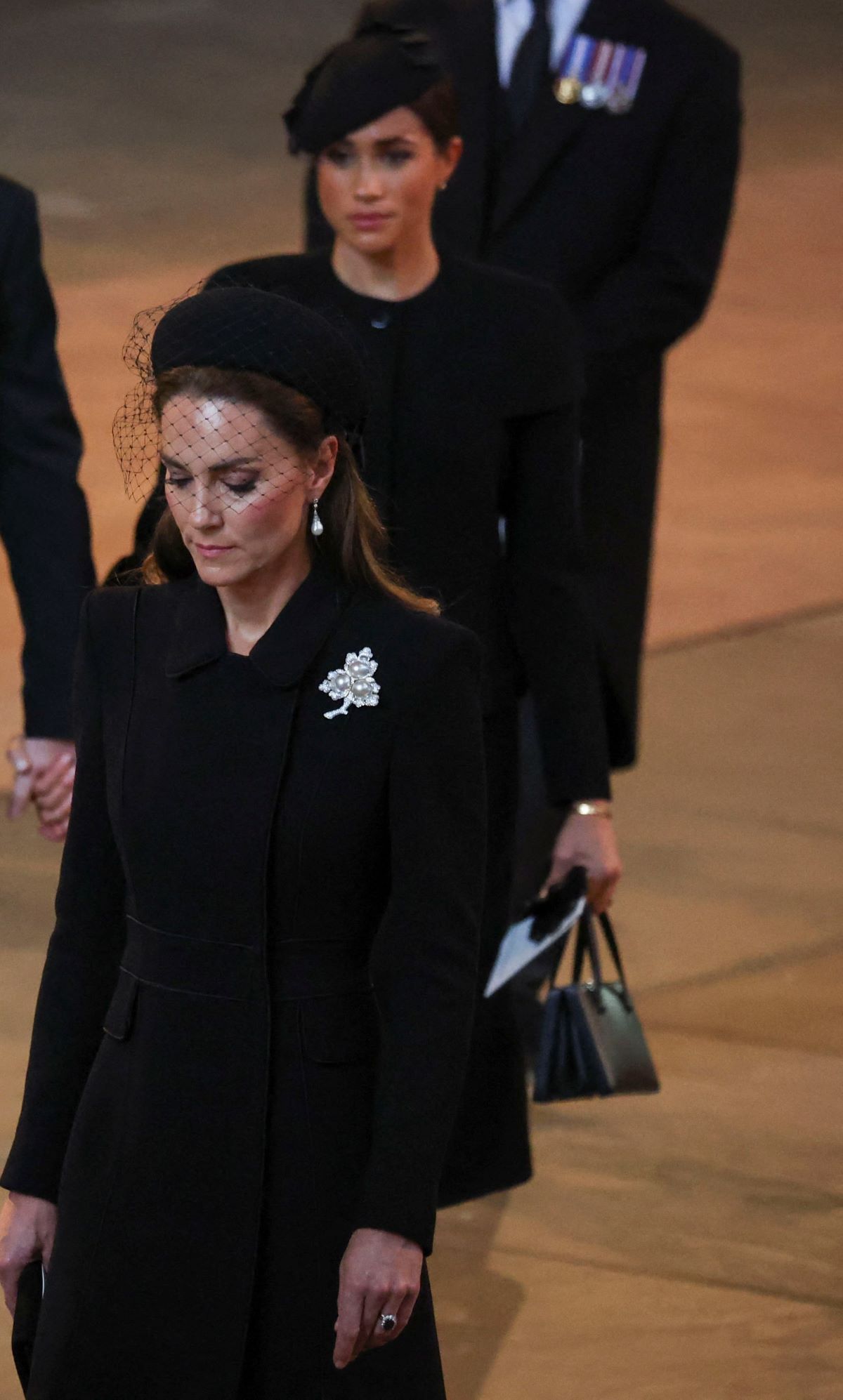 Kate Middleton and Meghan Markle walk in a procession behind the coffin of Queen Elizabeth II