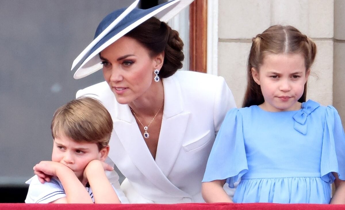 Kate Middleton standing on the Buckingham Palace balcony with Prince Louis and Princess Charlotte