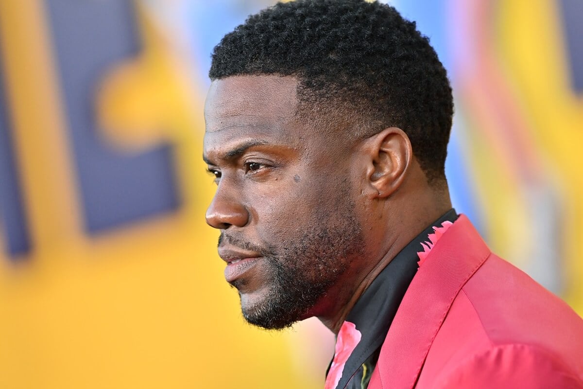 Kevin Hart posing in a red suit at the Los Angeles Premiere of Netflix's "Me Time".