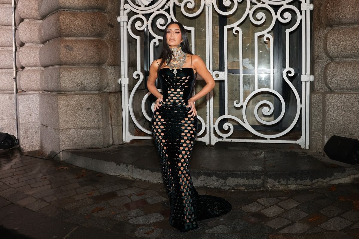 Kim Kardashian posing in a black dress at Paris fashion week.