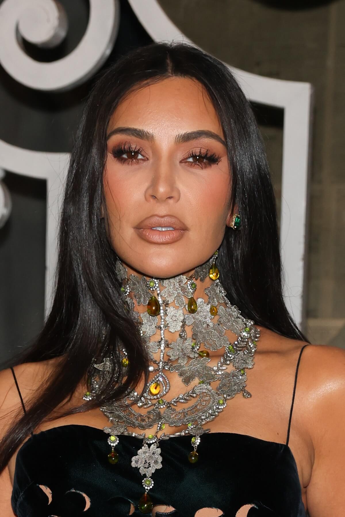 Kim Kardashian posing in a big necklace at Paris Fashion Week.