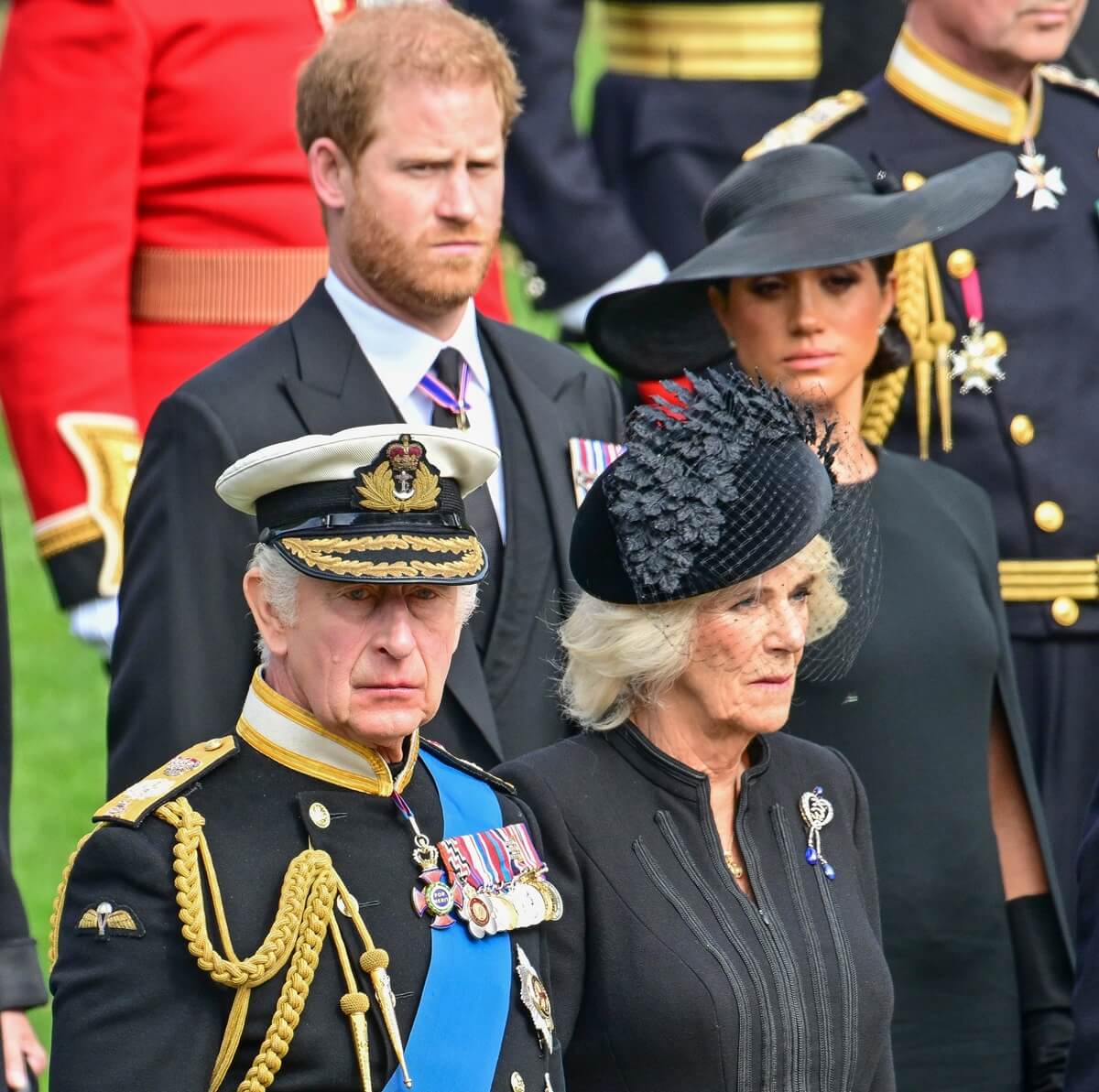 King Charles III, Queen Camilla, Prince Harry, and Meghan Markle observe the coffin of Queen Elizabeth II during her funeral