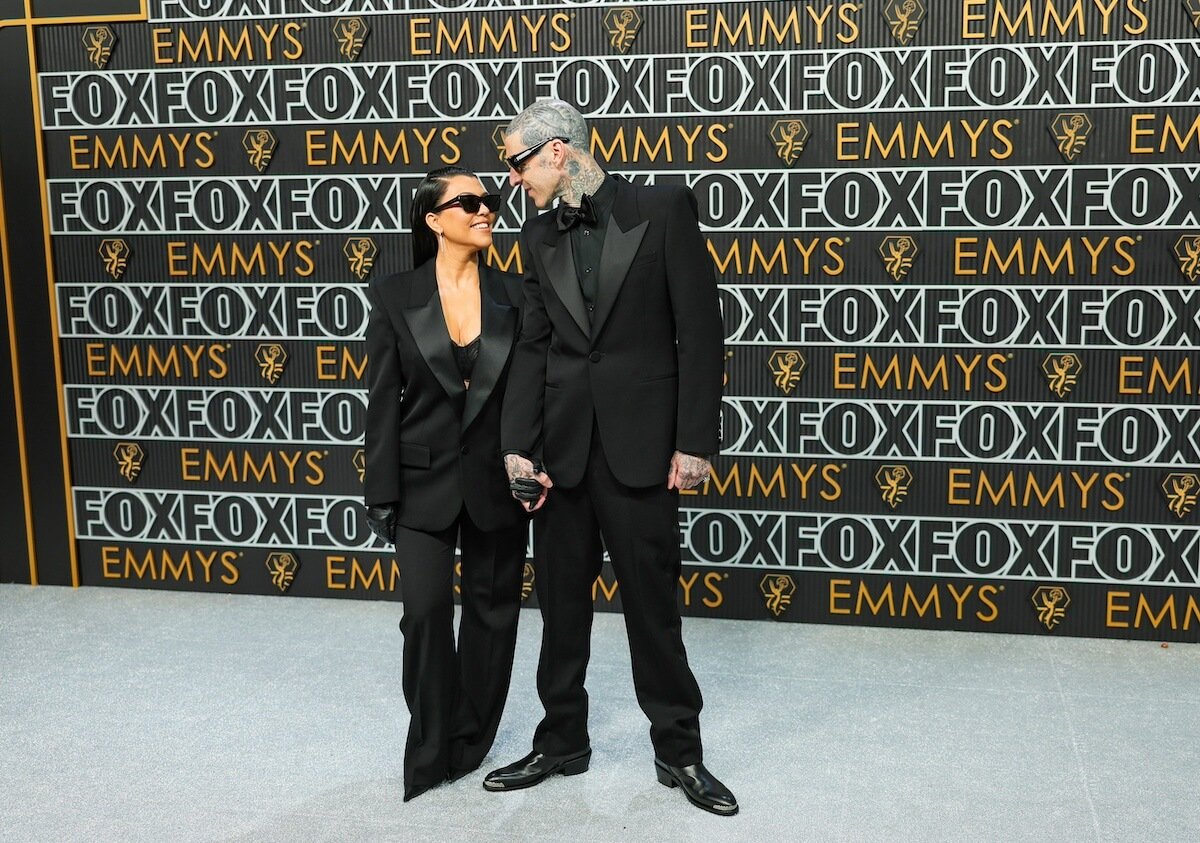 Travis Barker and Kourtney Kardashian look at each other on the Emmys red carpet