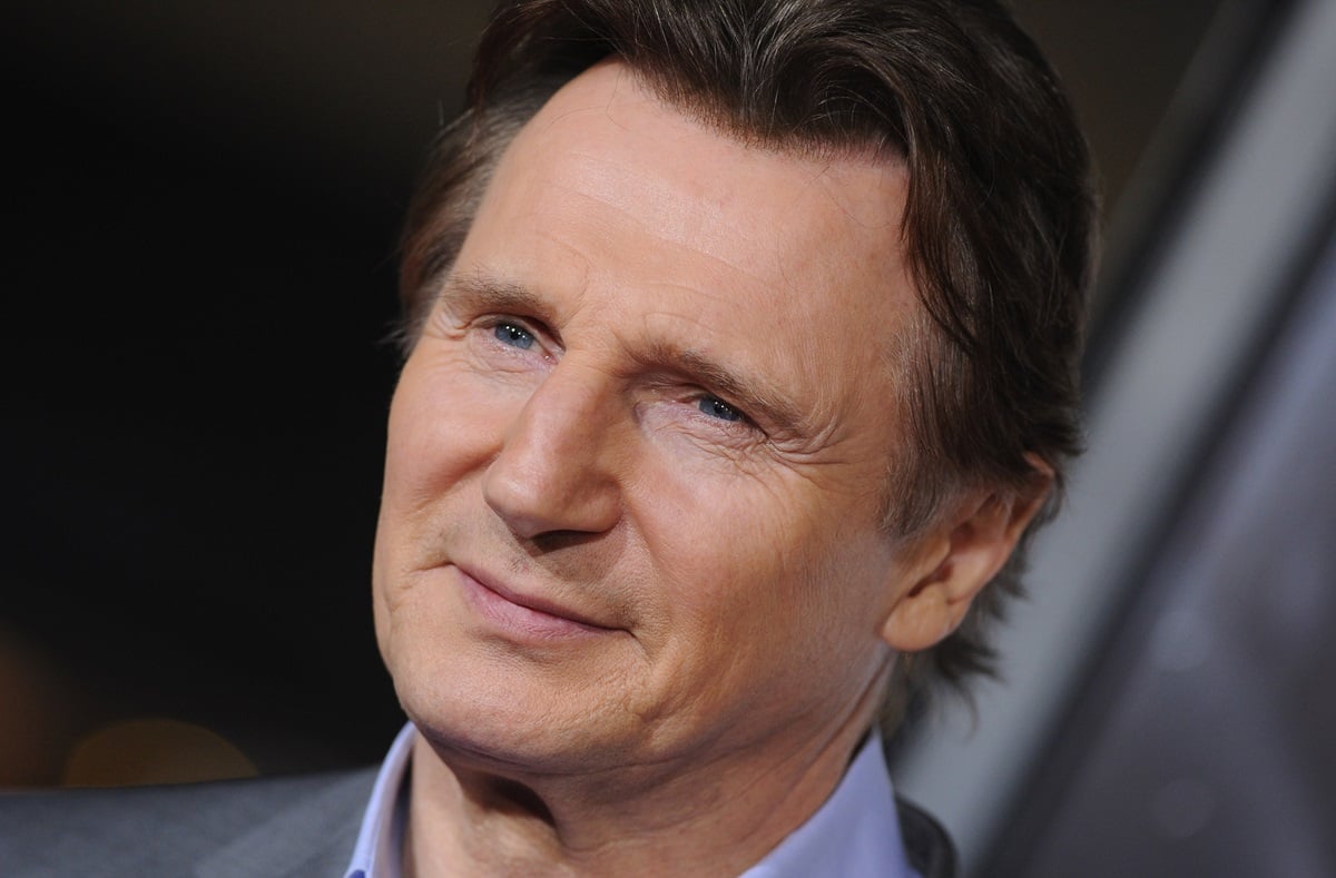 Liam Neeson posing in a suit at the the Los Angeles premiere of 'Non-Stop' at Regency Village Theatre.