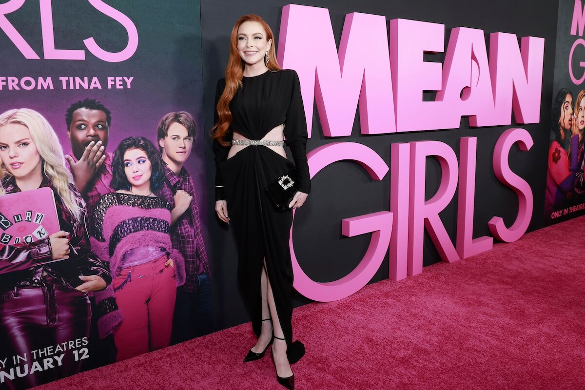 Lindsay Lohan, in a long-sleeved black dress with side cutouts and a front slit, at the 'Mean Girls' premiere