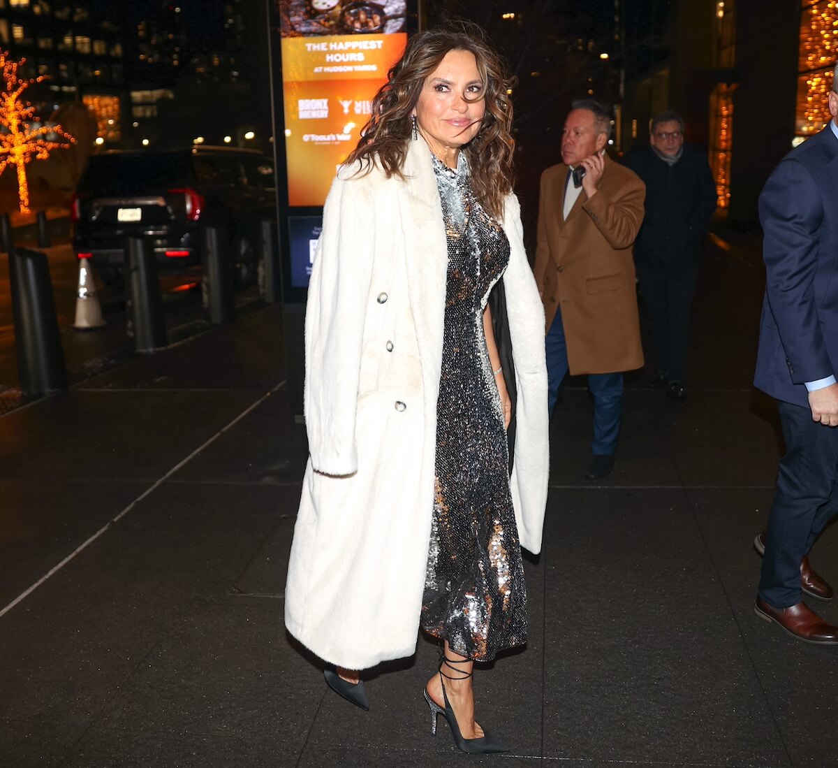 Mariska Hargitay in a white coat and silver dress