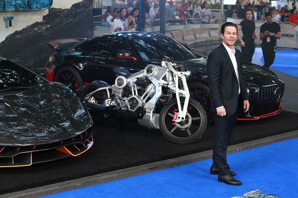 Mark Wahlberg posing at the global premiere of global premiere of "Transformers: The Last Knight" while wearing a suit.