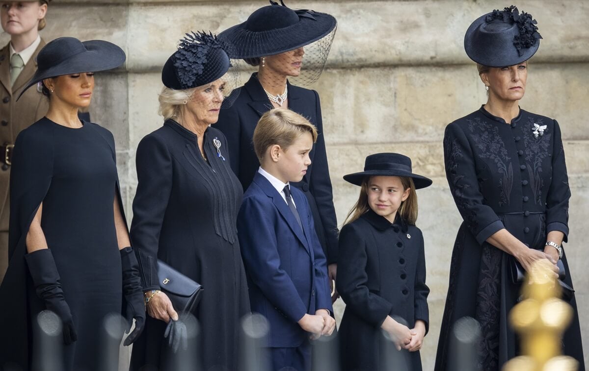Meghan Markle, Kate Middleton, Queen Camilla, Prince George, Princess Charlotte, and Sophie look on after the state funeral of Queen Elizabeth II