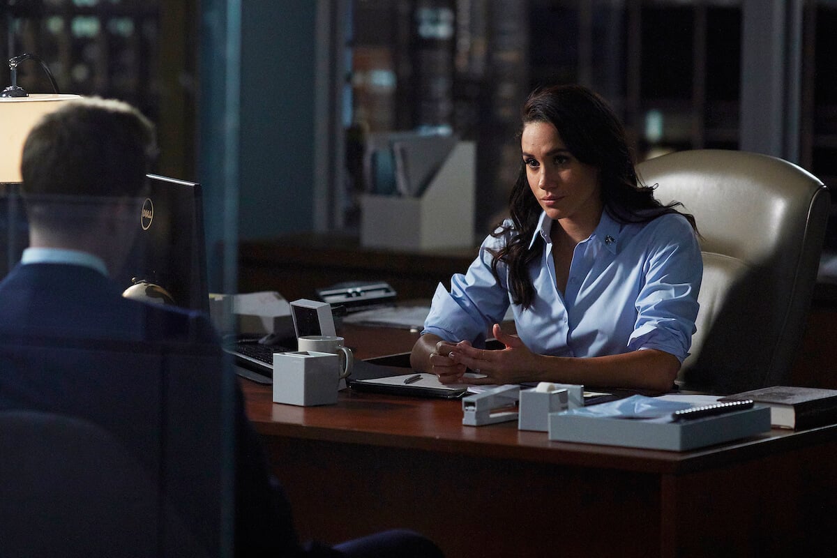 Meghan Markle, who may get involved in the 'Suits' spinoff 'Suits Los Angeles, sits at a desk in 'Suits' Season 6