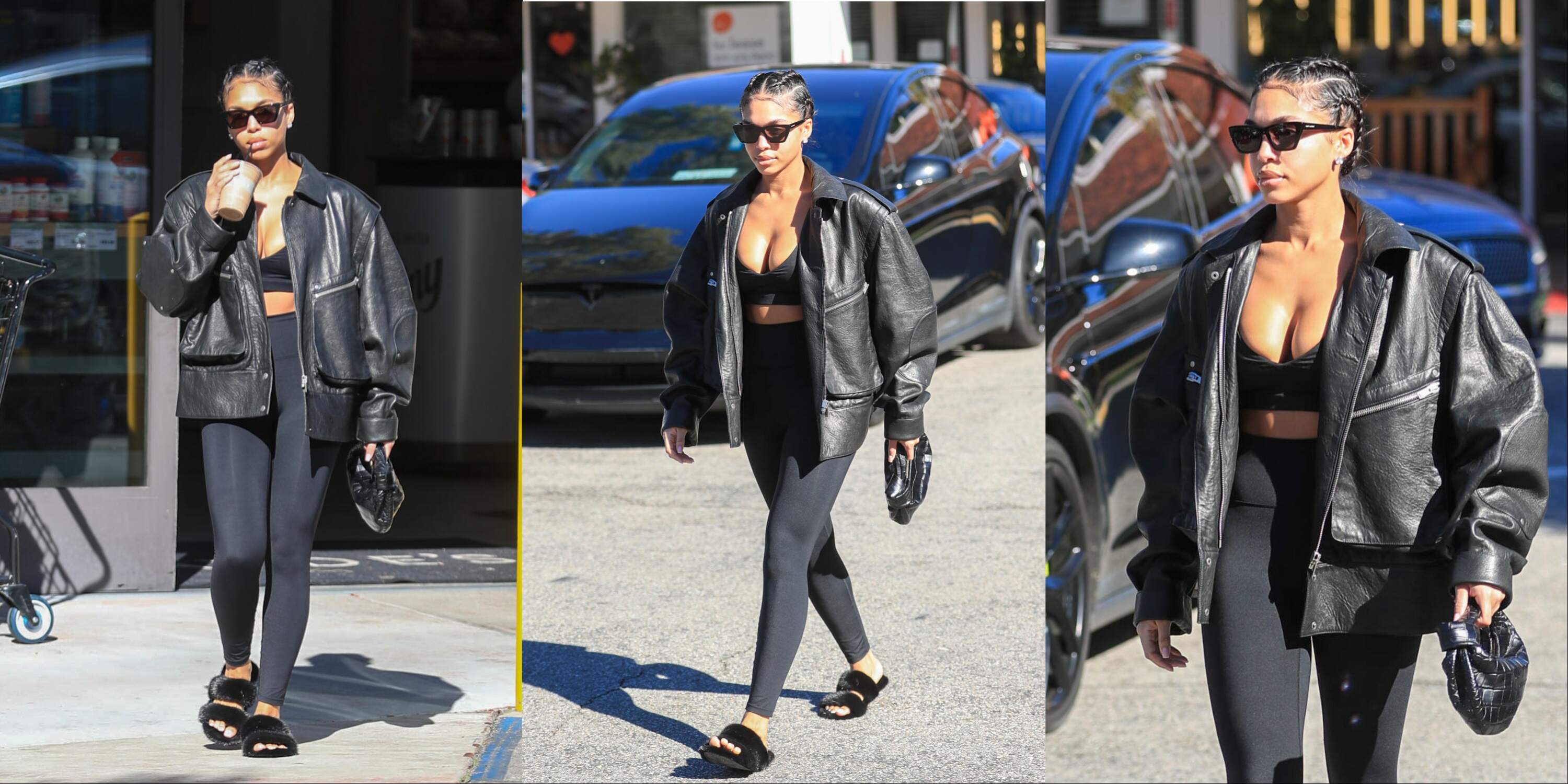 Model Lori Harvey picks up an iced coffee on a sunny day in LA while wearing a leather jacket and black leggings