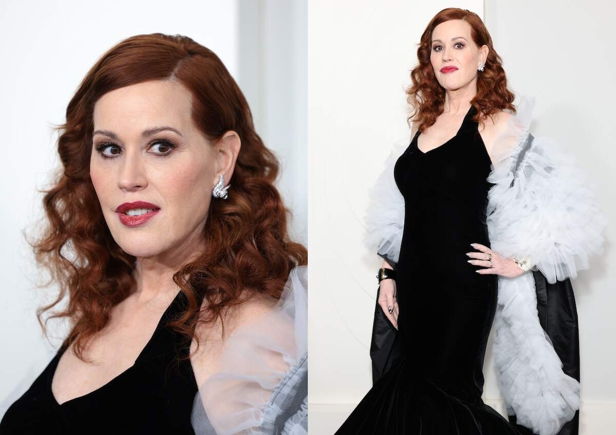 Actor Molly Ringwald puts her hand on her hip as she poses on the red carpet in a black gown and red lipstick