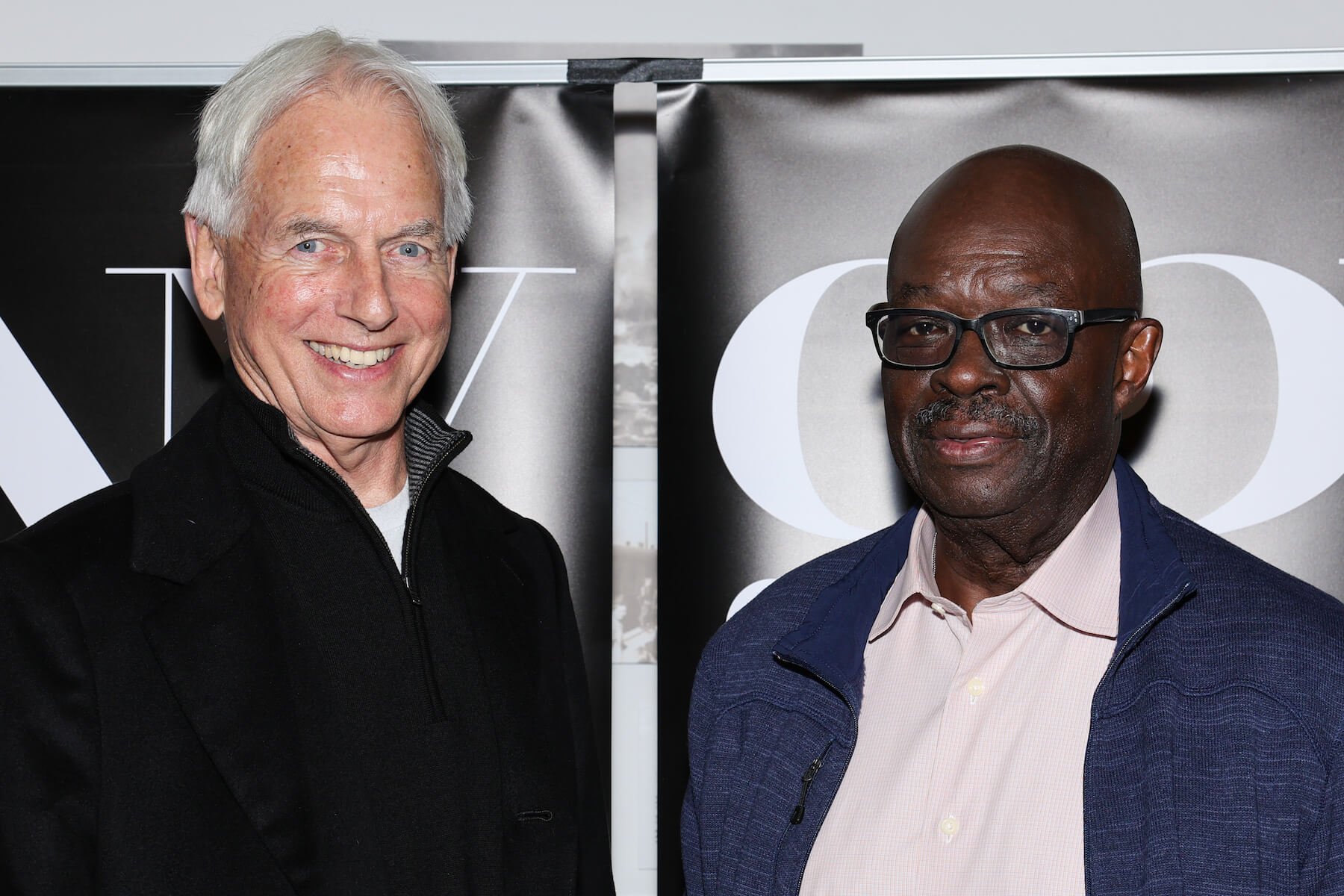 'NCIS' star Mark Harmon smiling next to Leon Carroll Jr. as they promote their new book