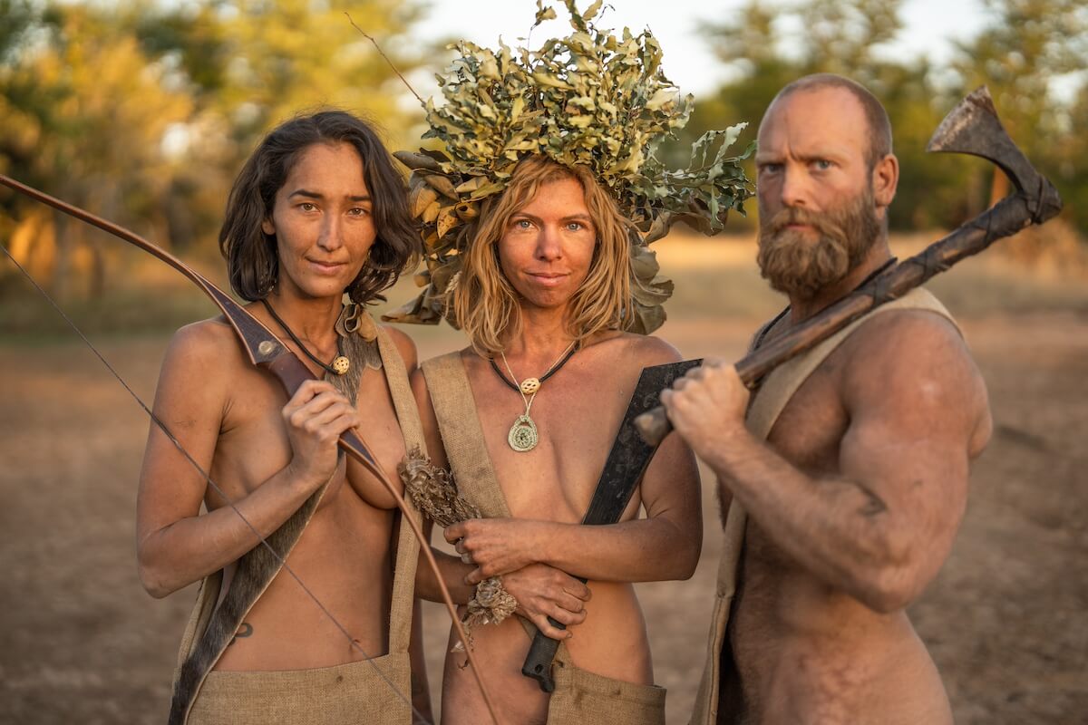 Three survivalists posing with their weapons on 'Naked and Afraid'