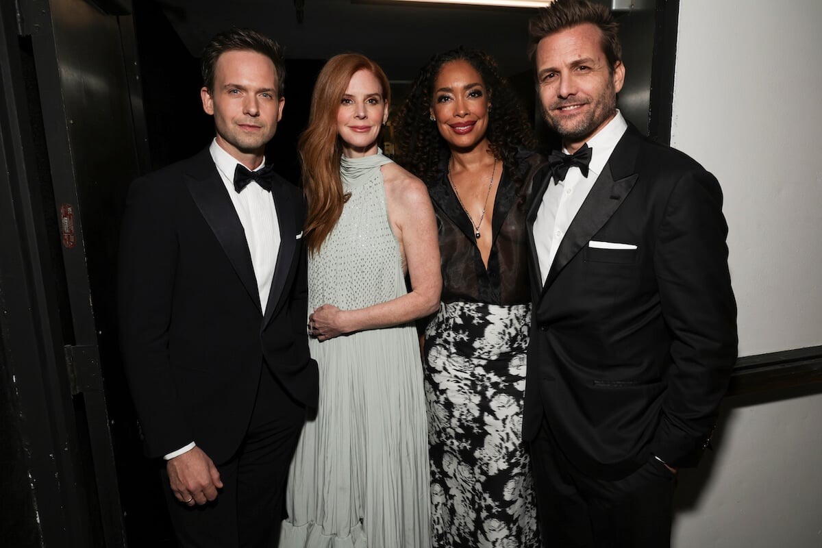 Patrick J. Adams, Sarah Rafferty, Gina Torres, and Gabriel Macht stand together at the Golden Globes