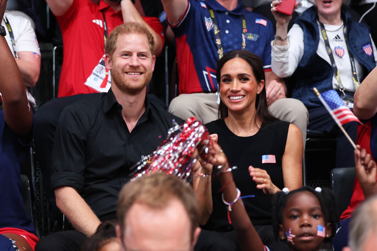 Prince Harry and Meghan Markle, whose 2024 'comeback' risks 'apathy' from the public, sit next to each other