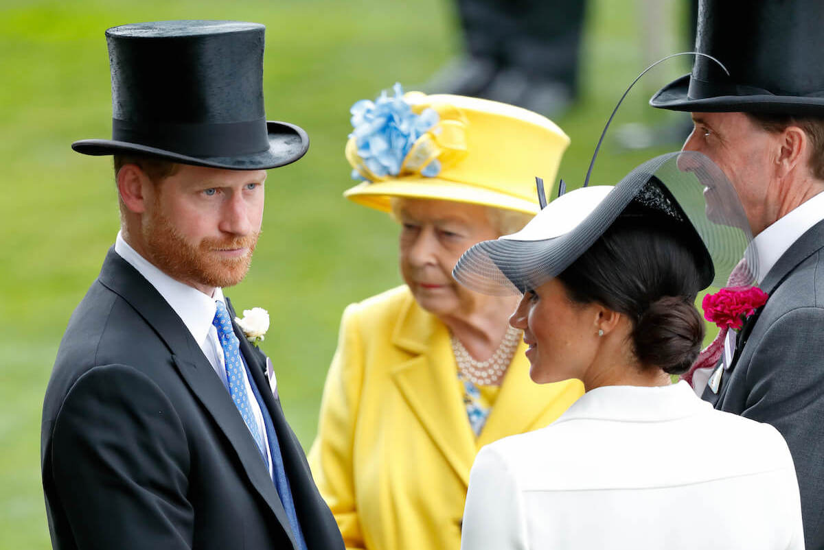 Prince Harry and Meghan Markle, whose daughter Princess Lilibet is named after Queen Elizabeth II, stand with the late monarch