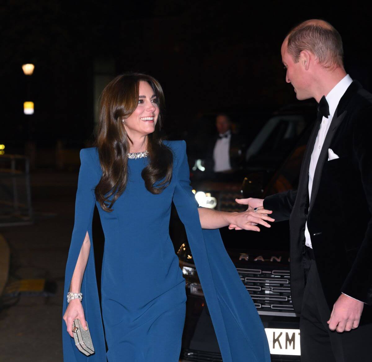Prince William reaches for his wife Kate Middleton's hand as they arrive to attend The 2023 Royal Variety Performance in London