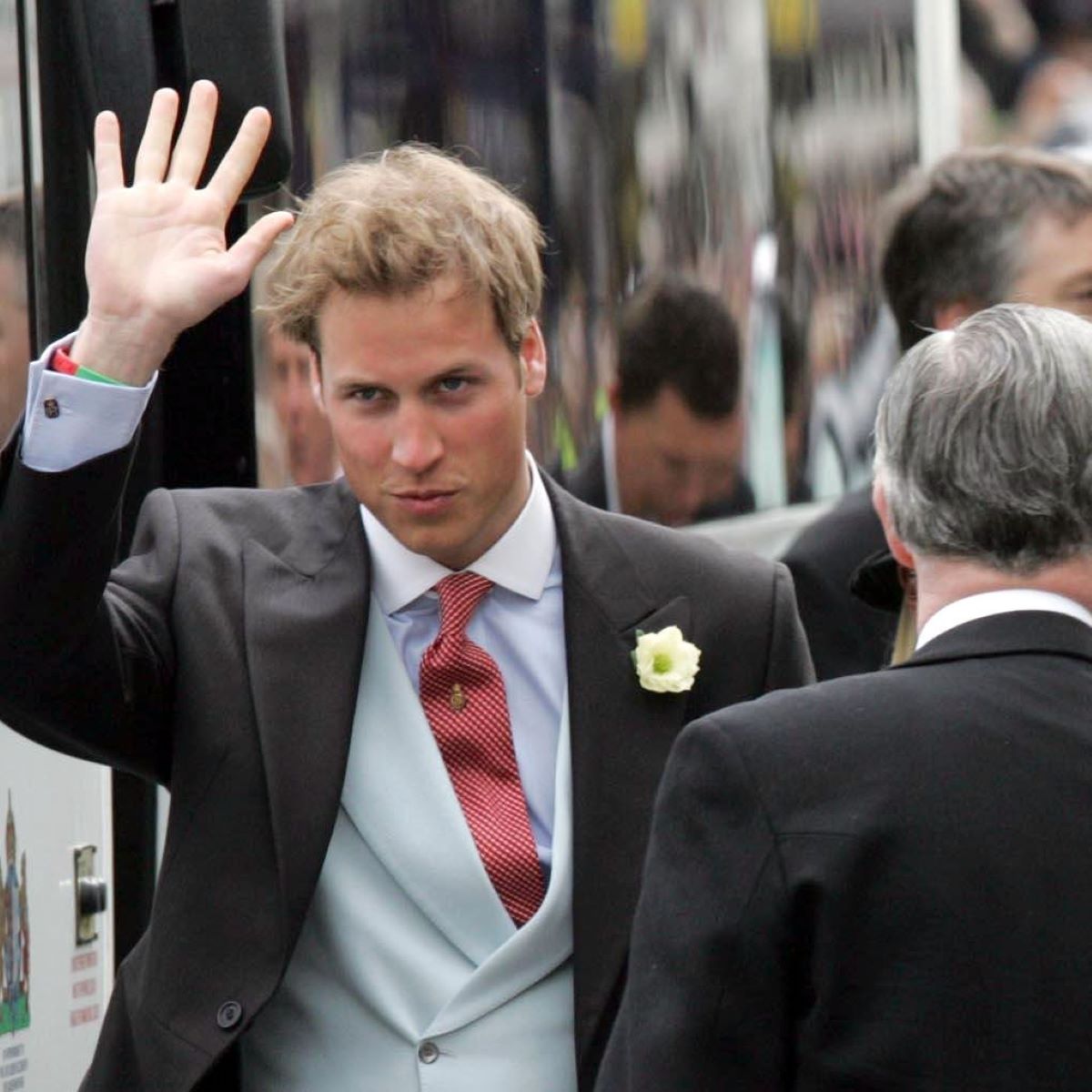 Prince William waves to onlookers as he arrives to the wedding of his father, then-Prince Charles and Camilla Parker Bowles