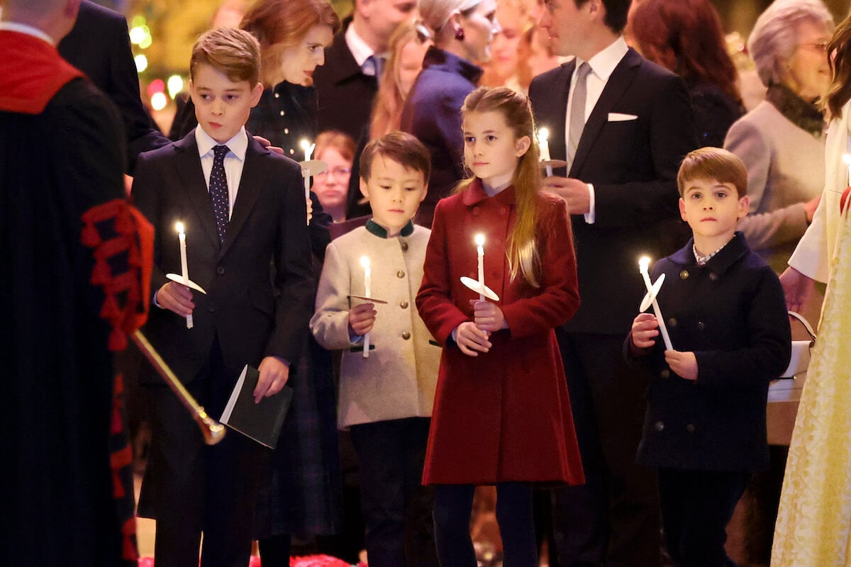 Princess Charlotte, who is reportedly 'very popular' at school, stands with Prince George and Prince Louis as the three hold lit candles