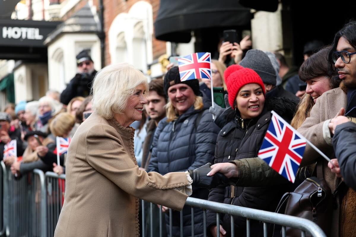 Queen Camilla shaking hands with supporters