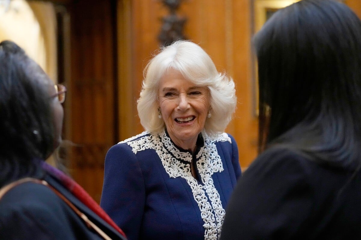 Queen Camilla smiling and laughing during reception at Windsor Castle for authors, illustrators, and binders