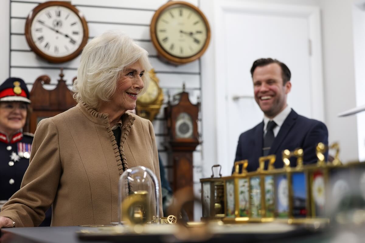 Queen Camilla in a clock shop