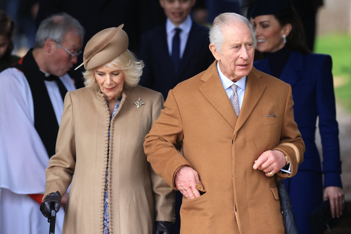 Queen Camilla, who wants King Charles to 'slow down' amid enlarged prostate hospital stay, walks with King Charles III