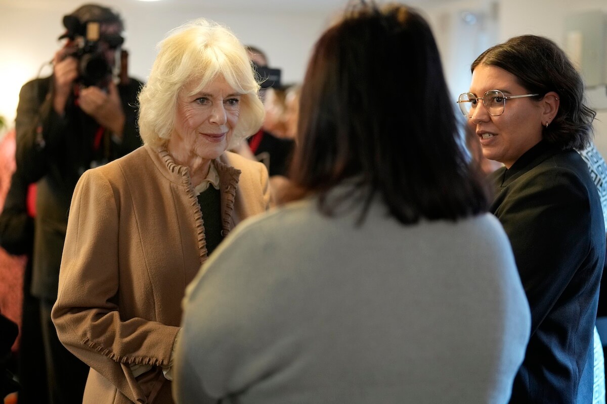 Queen Camilla talking to two women