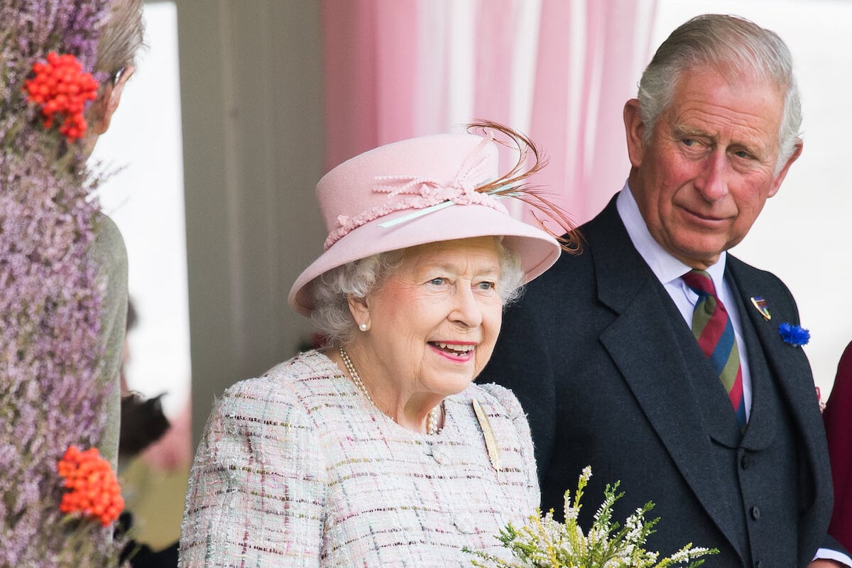 Queen Elizabeth II, whose death King Charles was told of with two words, per a royal biography, looks on standing with his late mother