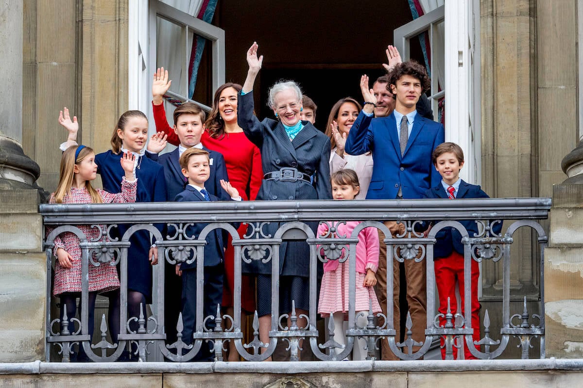 Queen Margrethe and other members of Denmark's royal family wave from a balcony. They are the subject of a new TV show similar to 'The Crown.'