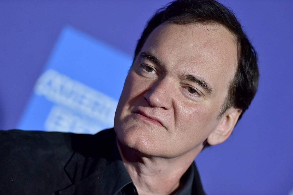 Quentin Tarantino posing at the the 2020 Annual Palm Springs International Film Festival Film Awards Gala wearing a black suit.