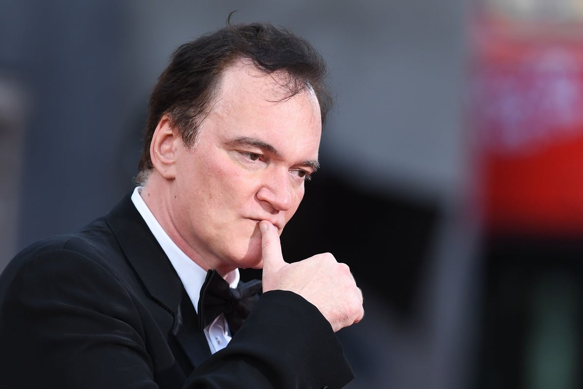 Quentin Tarantino posing in a suit at the premiere of 'Once Upon a Time...in Hollywood'.