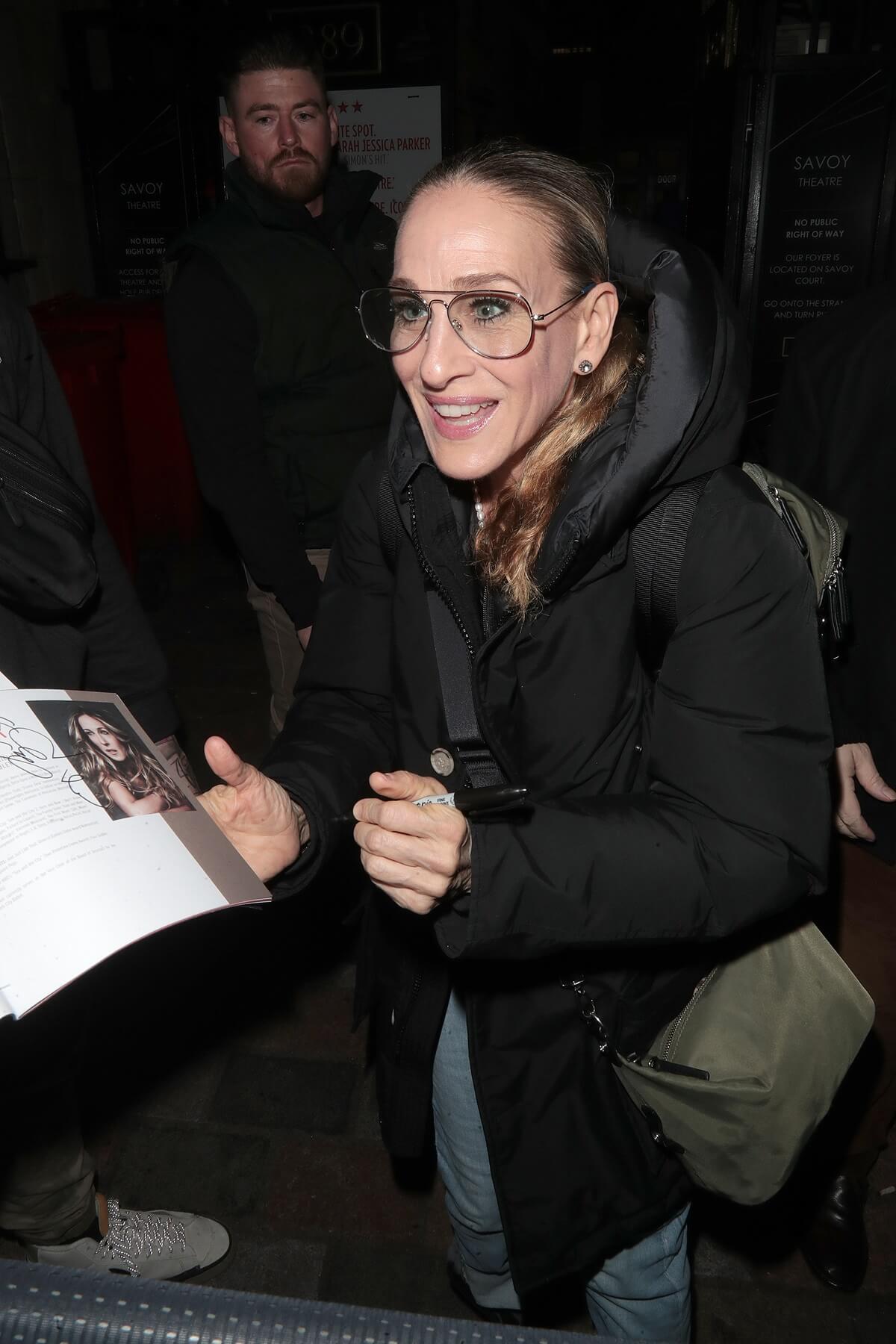 Sarah Jessica Parker seen at Savoy Theatre after her performance in "Plaza Suite" wearing a black coat.