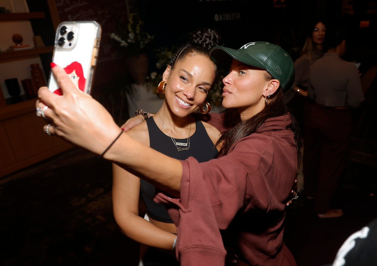 Alicia Keys takes a selfie with a fan