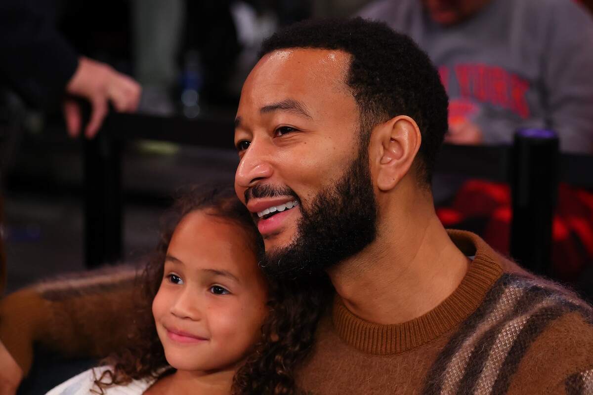 John Legend and his daughter watch a game between the New York Knicks and Milwaukee Bucks in 2023