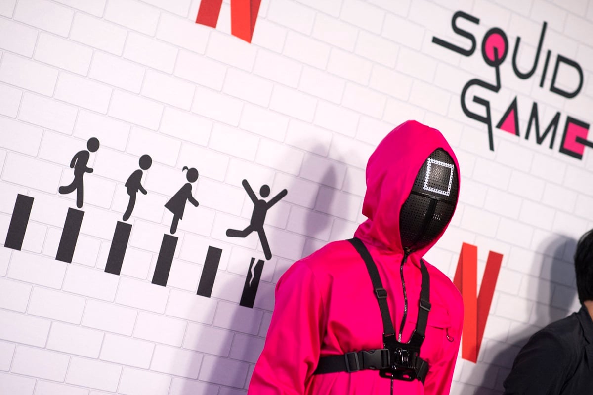 Person dressed up in a 'Squid Game' guard outfit while at the show's premiere.