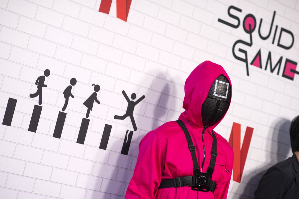 Person dressed up in a 'Squid Game' guard outfit while at the show's premiere.