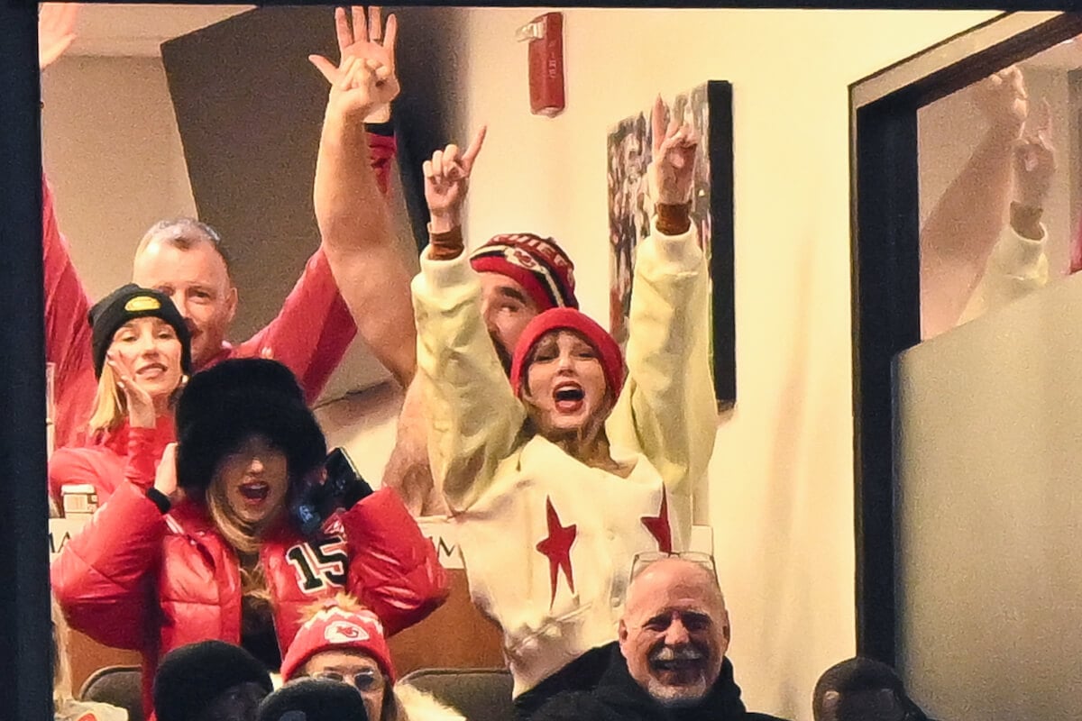Taylor Swift raises her hands above her head at the Jan 21, 2024 Chiefs game where Travis Kelce made a heart with his hands after scoring a touchdown