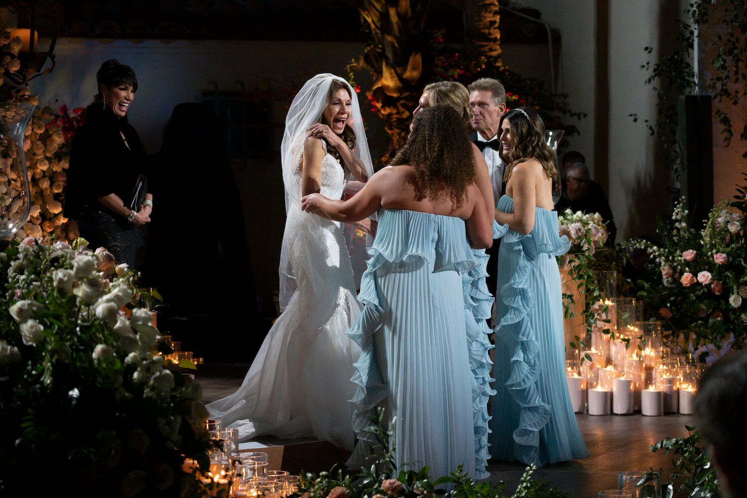 'The Golden Bachelor' wedding showing Theresa Nist in a wedding dress surrounded by bridesmaids dressed in light blue